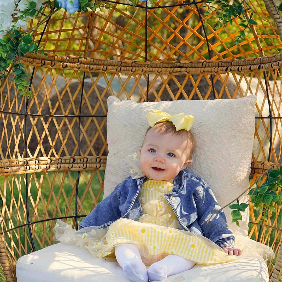 Braylee is registered to the contest to win money with this photo: architecture, baby, backyard, building, clothing, cushion, face, grass, head, homedecor, nature, outdoors, pants, person, photography, plant, portrait, pottedplant, sitting, yard