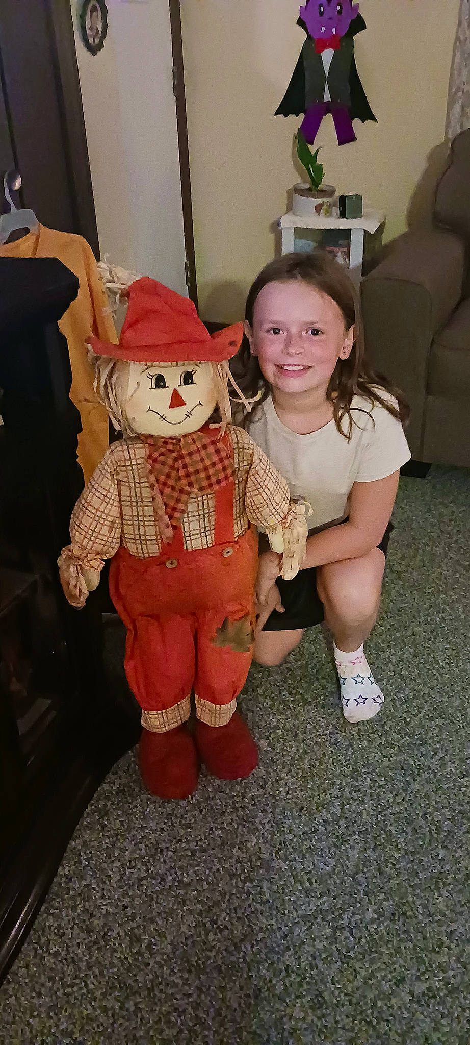 Andrea Lucille is registered to the contest to win money with this photo: child, costume, couch, event, fictional_character, flooring, fun, fur, happy, hat, human_leg, joy, lap, mascot, person, room, sitting, smile, sock, thigh