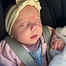 baby, infant, sleeping, car_seat, headband, bow, blanket, pink_sweater, denim_overalls, child, seatbelt, cozy, cute, peaceful, indoors, portrait, soft_texture, newborn, resting, toddler