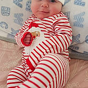 Kato joined the competition — help win amazing prizes! baby, infant, santa_hat, striped_pajamas, red_and_white, blanket, bed, rosy_cheeks, smile, cute, hand, foot, lying_down, cozy, christmas, festive, portrait, hat, face, person