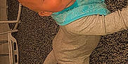 Leo is registered to the contest to win money with this photo: baby, child, crawling, carpet, floor, onesie, bib, indoor, furniture, chair, table, smiling, face, head, person, young_child, cute, looking_up, carpeted_floor, home