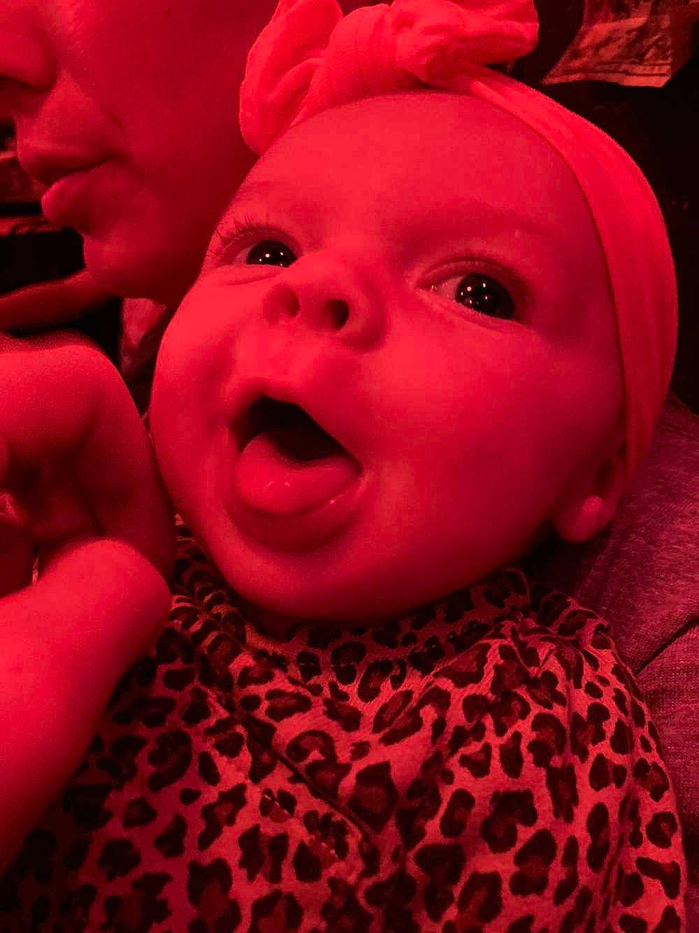Caroline is registered to the contest to win money with this photo: baby, carmine, cheek, chin, close_up, eye, fun, gesture, happy, human_body, lip, magenta, mouth, nose, person, pink, red, skin, smile, thumb