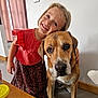 Hélya participe au concours pour gagner de l'argent avec cette photo : child, dog, indoor, smiling, happy, pet, animal, girl, affection, friendship, casual_clothing, table, curtain, floor, wooden_surface, remote_control, bottle, yellow_lid, wall_socket, portrait