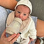 élio participe au concours pour gagner de l'argent avec cette photo : baby, bottle, feeding, hat, knitwear, striped_socks, person, hand, cozy, infant, newborn, clothing, indoor, care, love, soft, comfort, feeding_time, cute, warm