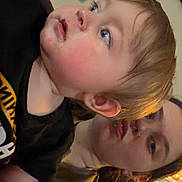 Waylon is registered to the contest to win money with this photo: adult, black_shirt, casual, cheeks, child, clothing, curious, expression, eyebrows, face, hair, home, indoor, lighting, looking_away, person, portrait, seated, skin, toddler