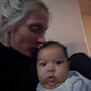 Skylah is registered to the contest to win money with this photo: baby, infant, woman, adult, kiss, snuggling, blur, closeup, portrait, indoor, couch, living_room, affection, family, parent_and_child, holding, soft_lighting, hair, eyes, clothing