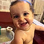baby, child, smile, wet, bath, toy, face, skin, curly_hair, indoors, tiled_wall, happy, closeup, cute, infant, playful, water_drops, teeth, expression, person