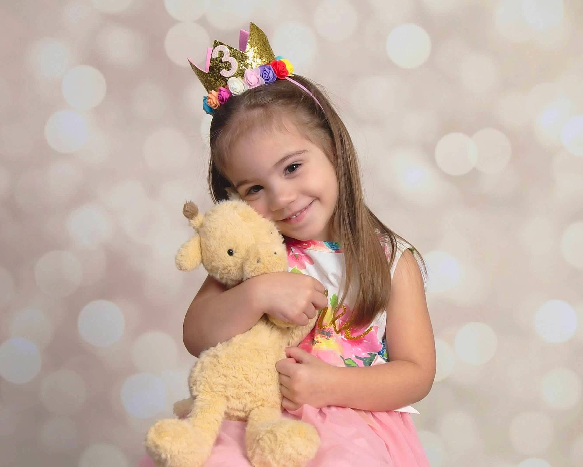 Isabella is registered to the contest to win money with this photo: baby_toddler_clothing, beauty, child, event, face, fawn, fun, happy, joy, mammal, party_hat, people_in_nature, person, pink, skin, smile, stuffed_toy, teddy_bear, toddler, toy