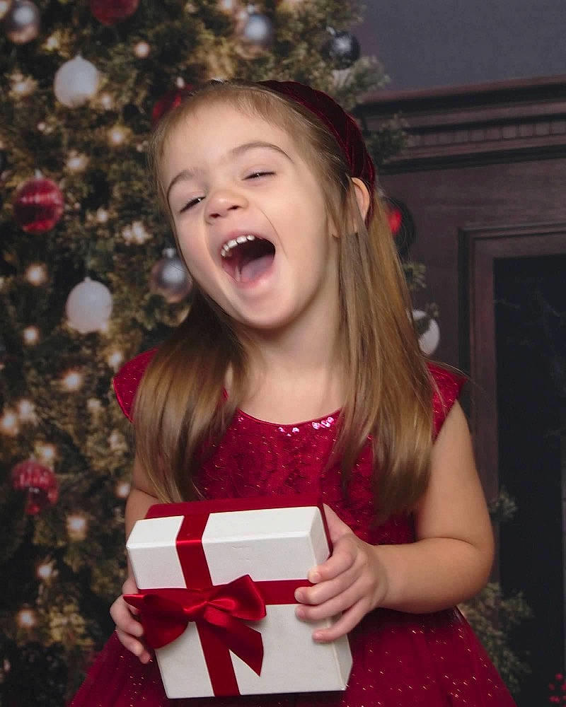 Isabella joined the competition — help win amazing prizes! blond, child, christmas, christmas_eve, christmas_ornament, dress, event, flash_photography, fun, gesture, hairstyle, happy, holiday, lip, pattern, person, pink, sleeve, smile, standing