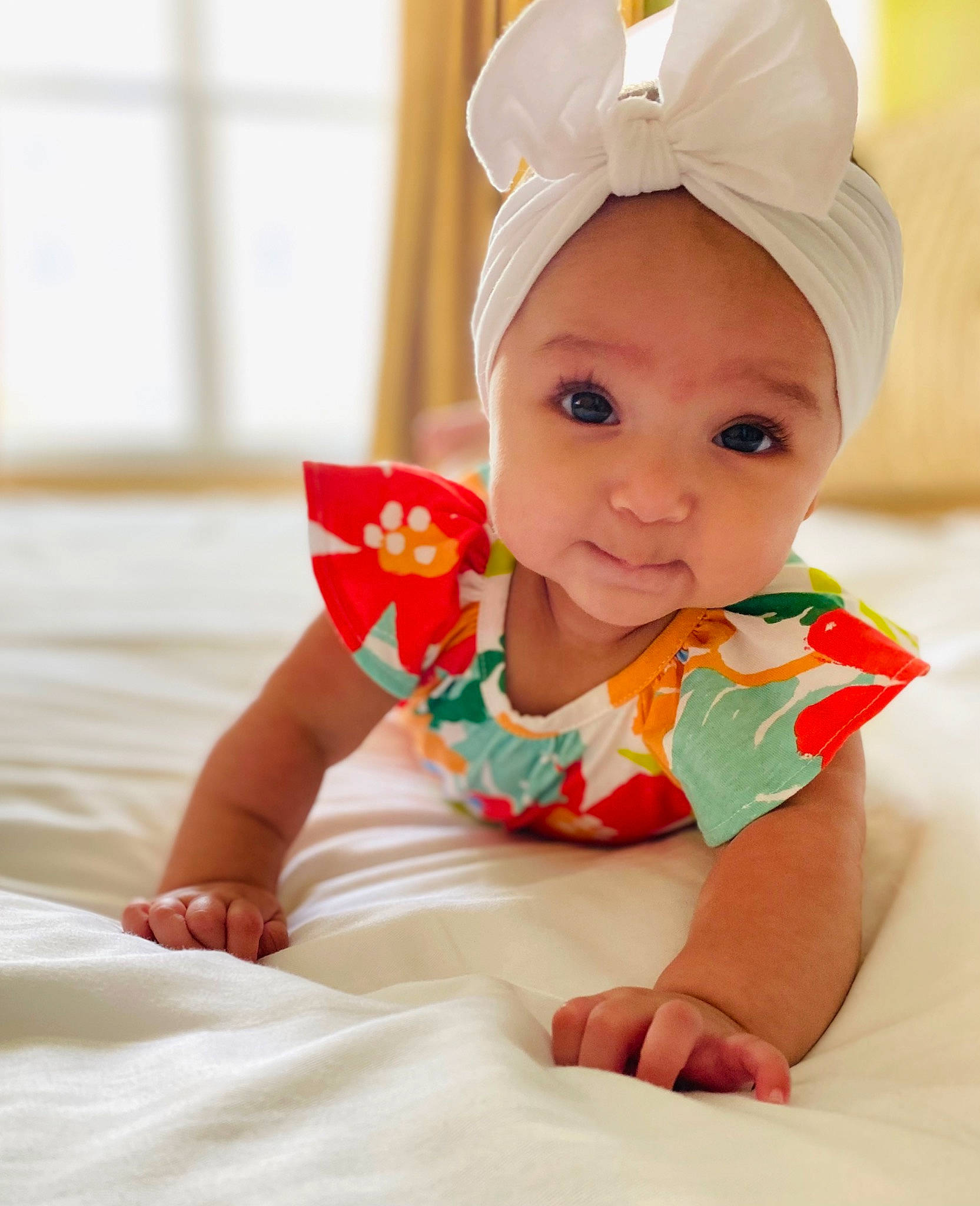 Winter is registered to the contest to win money with this photo: baby, baby_toddler_clothing, cap, child, comfort, face, facial_expression, fashion_accessory, fun, happy, headgear, human_leg, pattern, person, room, sitting, skin, sleeve, smile, t_shirt