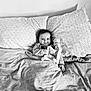 Lyam participe au concours pour gagner de l'argent avec cette photo : baby, bed, blanket, black_and_white, child, couch, cute, face, furniture, happy, head, indoors, pillow, plush_toy, portrait, resting, smile, soft_toy, toddler, young_child