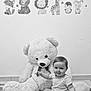 baby, teddy_bear, stuffed_animal, wall_decals, fox, bear, lion, giraffe, penguin, rabbit, stars, moon, carpet, indoor, child, smiling, sitting, cute, playful, nursery