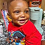 toddler, child, smiling, red_shirt, mickey_mouse, kitchen, countertop, keurig, coffee_box, happy, portrait, indoor, face, person, cute, baby, short_hair, bright_eyes, expression, clothing