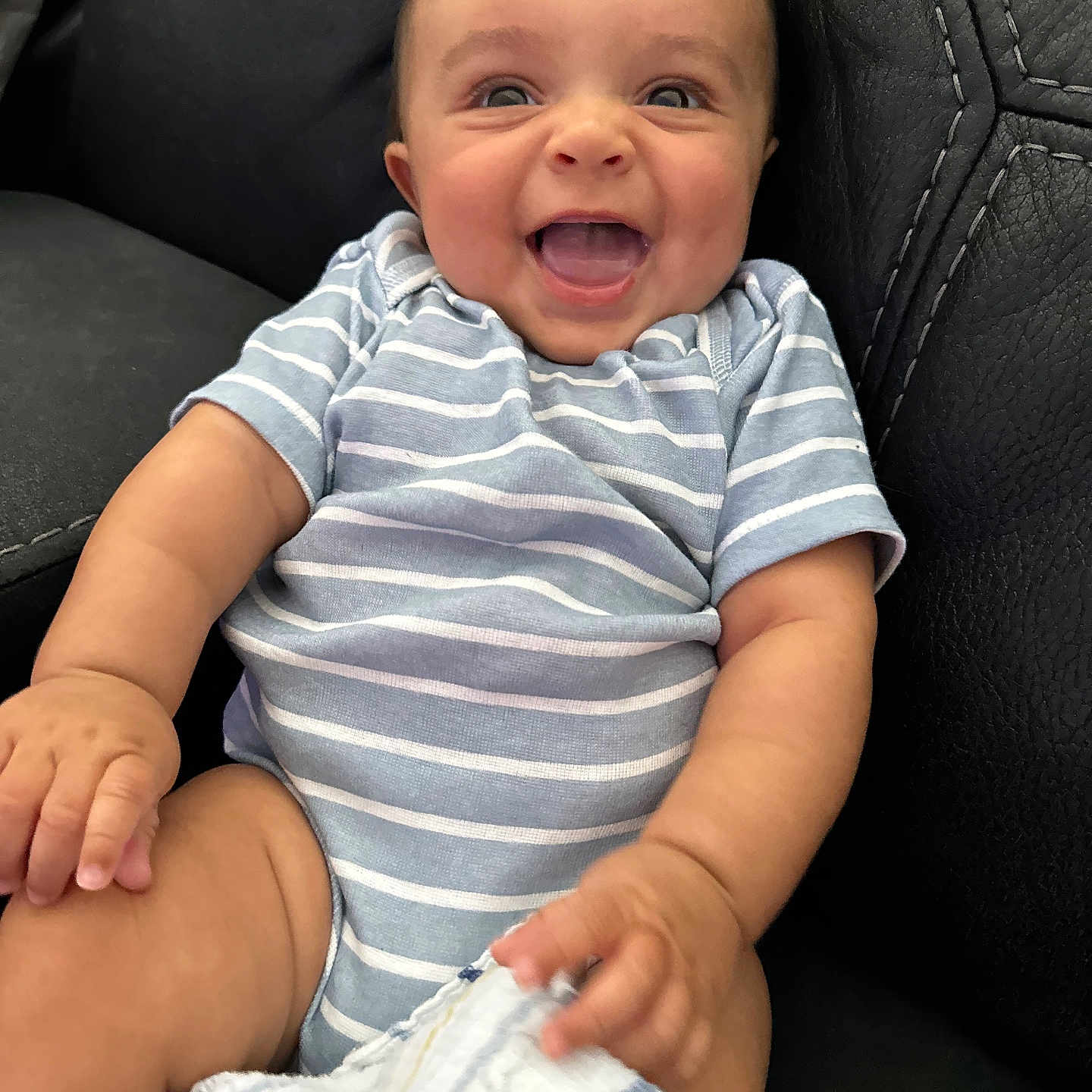 Brayden is registered to the contest to win money with this photo: baby, babylaughing, clothing, couch, diaper, face, furniture, happy, head, laughing, pants, person, photography, portrait, shorts, sitting, smile, t_shirt