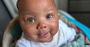 Jeremiah joined the competition — help win amazing prizes! baby, infant, smile, face, eyes, blanket, soft_texture, white_clothing, indoor, closeup, cute, child, portrait, happy, candid, young_child, cozy, warm_lighting, baby_boy, adorable