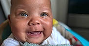 Jeremiah joined the competition — help win amazing prizes! baby, blanket, child, closeup, clothing, cozy, cute, expression, eyes, face, happy, head, indoors, infant, person, portrait, skin, smiling, soft, warm