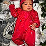 Drishti joined the competition — help win amazing prizes! baby, infant, red_onesie, headband, christmas, holiday, santa_doll, lantern, blanket, knit_hat, white_flower, greenery, cozy, cute, portrait, indoors, festive, celebration, newborn, holiday_decor