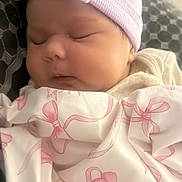 Franshesca is registered to the contest to win money with this photo: newborn, baby, sleeping, infant, portrait, hat, pink, blanket, clothing, bows, peaceful, indoors, close_up, face, eyes_closed, cozy, nursery, soft_lighting, resting, child
