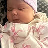 newborn, baby, sleeping, infant, portrait, hat, pink, blanket, clothing, bows, peaceful, indoors, close_up, face, eyes_closed, cozy, nursery, soft_lighting, resting, child