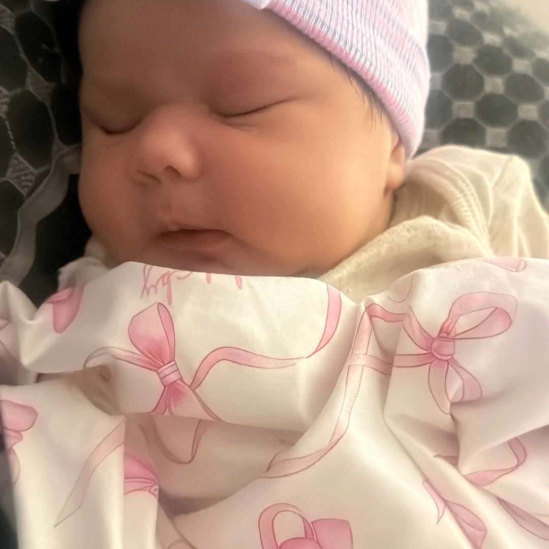 Franshesca is registered to the contest to win money with this photo: newborn, baby, sleeping, infant, portrait, hat, pink, blanket, clothing, bows, peaceful, indoors, close_up, face, eyes_closed, cozy, nursery, soft_lighting, resting, child
