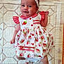 Ambre a rejoint le concours — aidez-le/la à gagner de superbes lots ! baby, infant, child, smiling, dress, headband, strawberry_pattern, lying_down, blanket, red, white, cute, happy, indoors, fabric, pattern, clothing, person, portrait, baby_girl