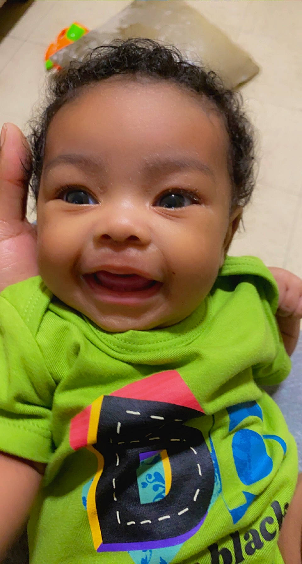 Alaska is registered to the contest to win money with this photo: baby, baby_toddler_clothing, cheek, child, close_up, ear, eyebrow, eyelash, forehead, fun, gesture, happy, iris, lip, mouth, nose, person, photograph, skin, smile