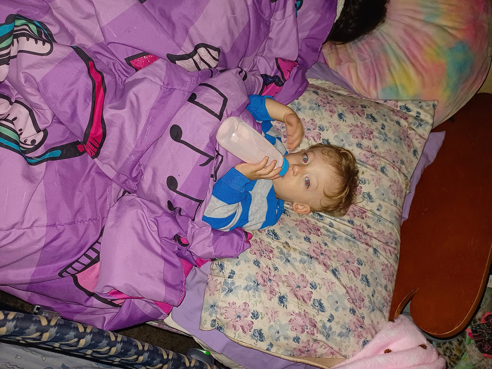 Hayden is registered to the contest to win money with this photo: baby, baby_products, baby_toddler_clothing, child, comfort, fun, happy, interaction, linens, magenta, pattern, person, pink, purple, room, sitting, textile, toddler, toy, violet