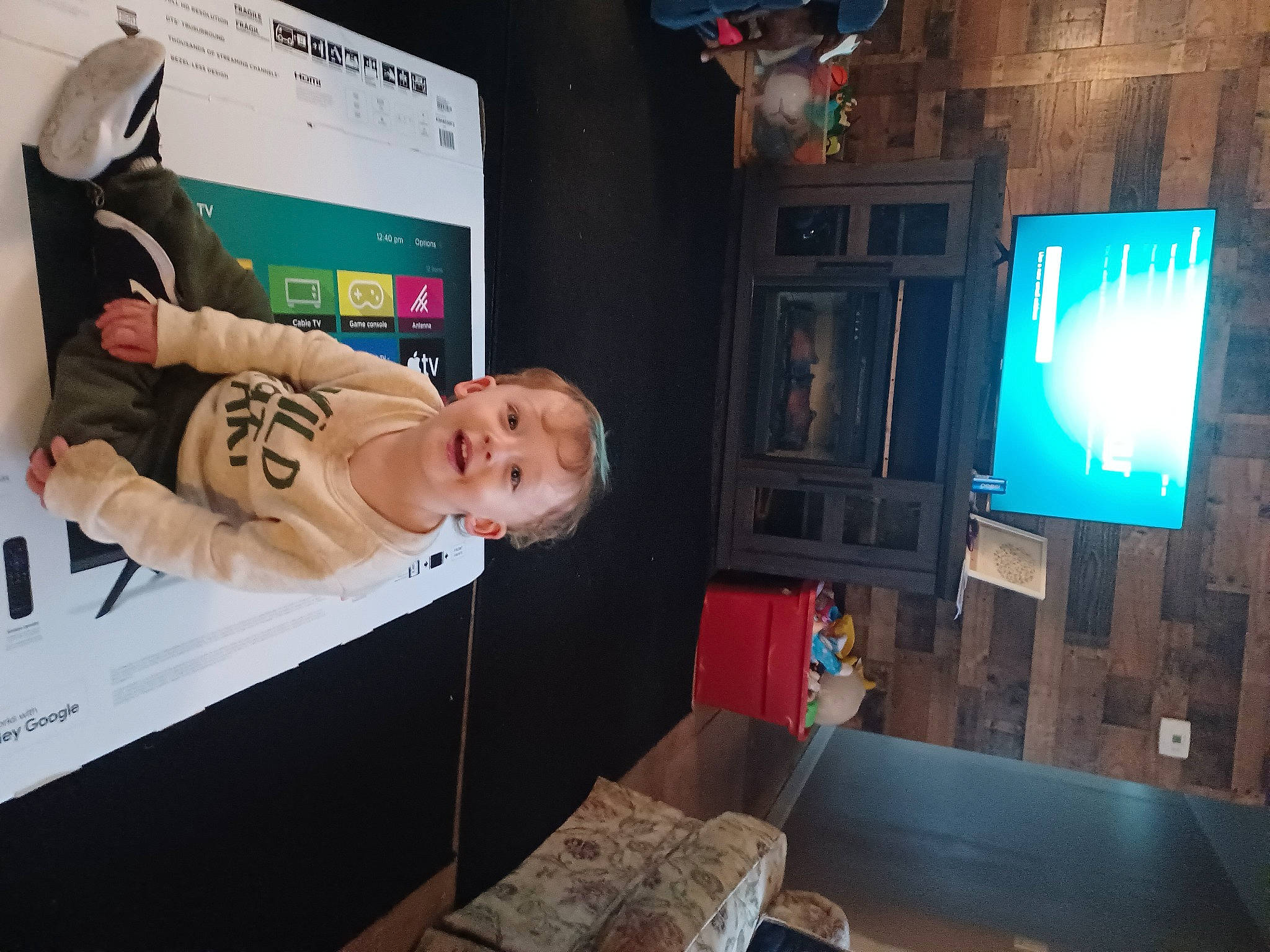 Hayden is registered to the contest to win money with this photo: baby, comfort, computer, desktop_computer, display_device, electronic_device, event, flat_panel_display, fun, gadget, led_backlit_lcd_display, leisure, machine, person, room, space, t_shirt, table, television, television_set