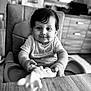 Soan a rejoint le concours — aidez-le/la à gagner de superbes lots ! baby, black_and_white, child, clothing, cute, expression, face, furniture, hair, hands, high_chair, indoor, infant, person, portrait, seat, smile, table, toy, young