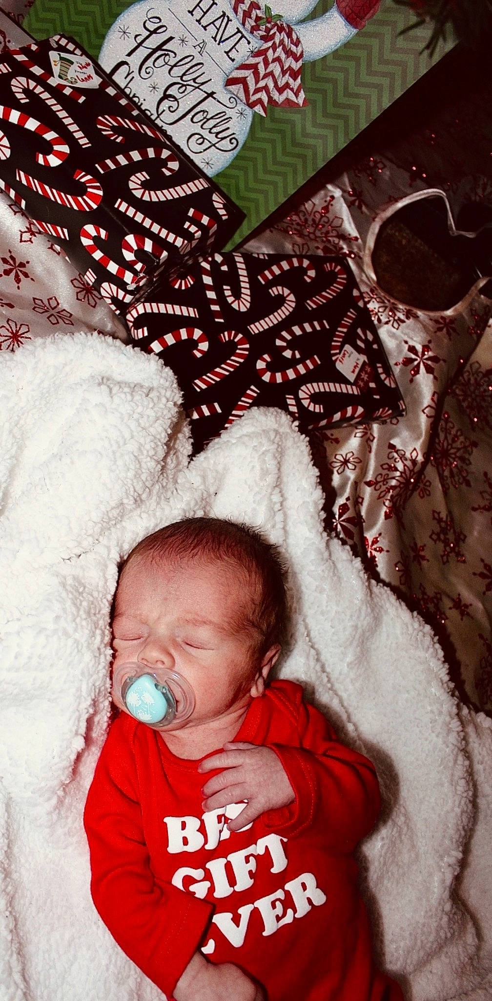 Canaan is registered to the contest to win money with this photo: baby, baby_sleeping, baby_toddler_clothing, black, child, comfort, event, fur, gesture, happy, holiday, linens, pattern, person, pink, product, red, skin, textile, toddler