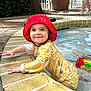 Azlynn joined the competition — help win amazing prizes! toddler, child, pool, water, swimsuit, red_hat, yellow_clothing, smiling, outdoor, summer, toys, water_toys, play, happy, baby, person, feet, palm_tree, plant_pot, fence