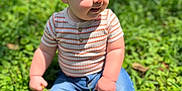 Crew is registered to the contest to win money with this photo: baby, blue_jeans, casual_clothing, child, cute, daylight, grass, greenery, happy, infant, nature, outdoor, person, portrait, red_sneakers, sitting, smiling, striped_shirt, sunlight, young_child