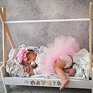 Maliya a rejoint le concours — aidez-le/la à gagner de superbes lots ! baby, sleeping, tutu, pink, flower_headband, pacifier, blanket, wooden_bed, indoor, cozy, infant, cute, child, floor_tiles, decorative_letters, soft_fabric, resting, newborn, toddler, nursery