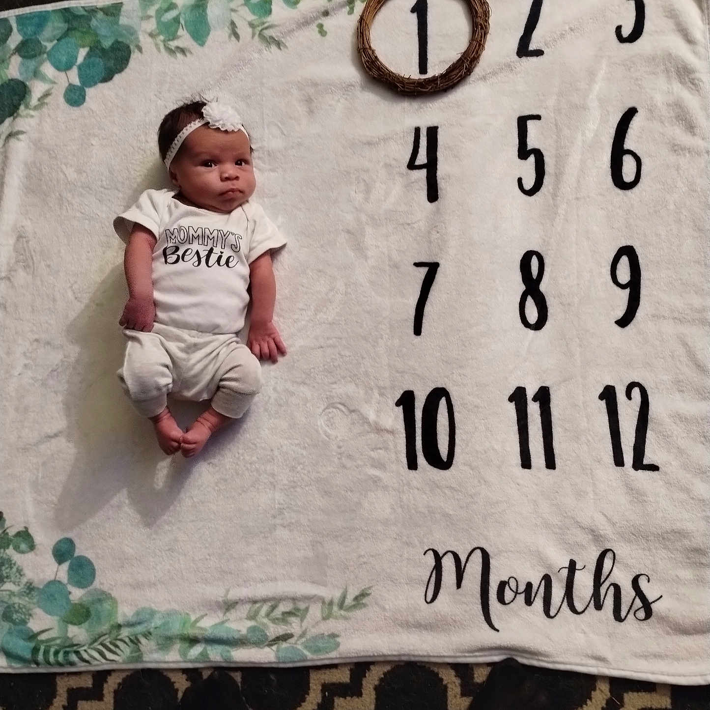 Nyilah joined the competition — help win amazing prizes! accessories, baby, bed, blanket, clothing, face, hat, head, homedecor, newborn, number, person, photography, portrait, quilt, shorts, sitting, symbol, t_shirt, text