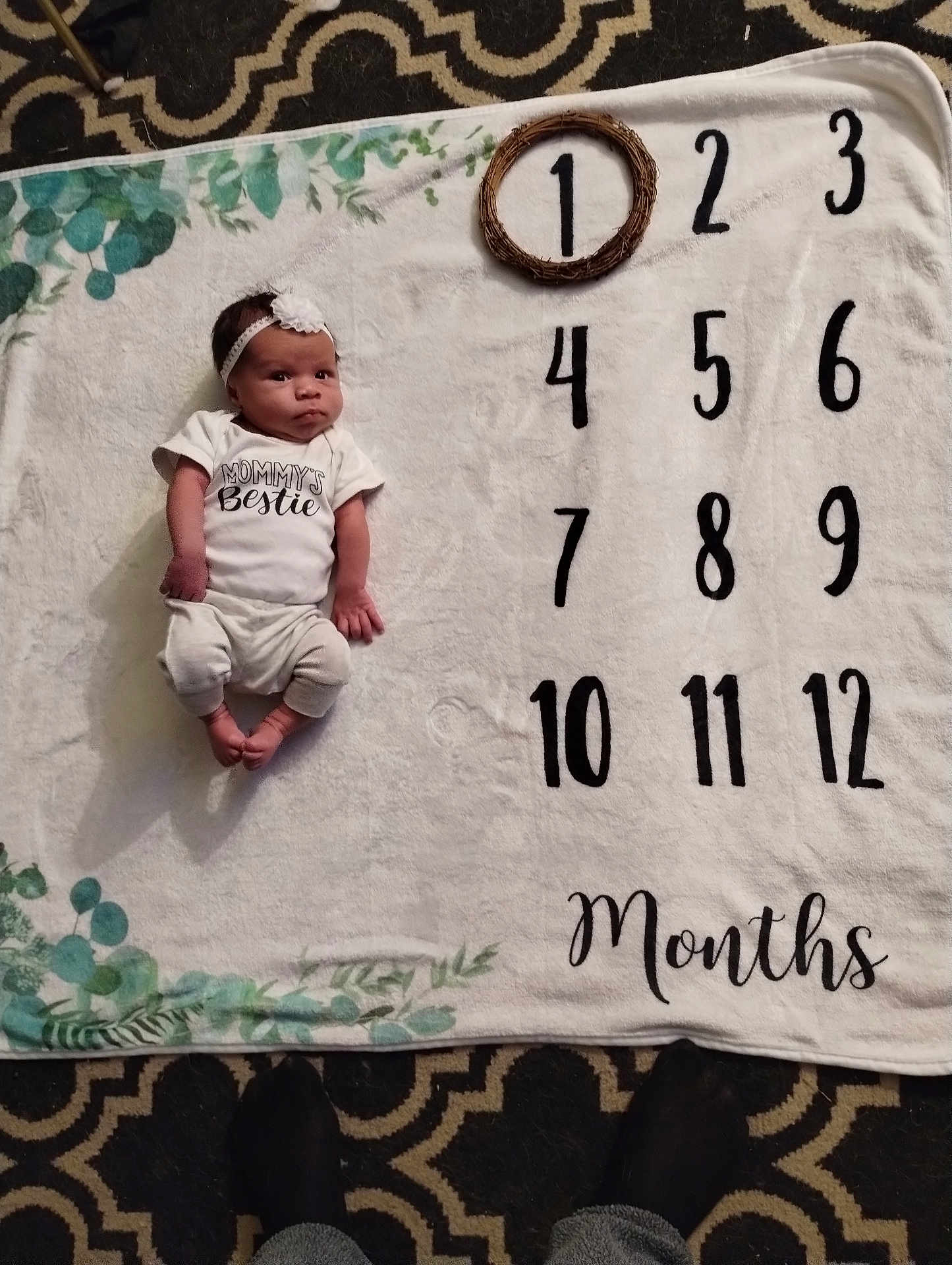 Nyilah joined the competition — help win amazing prizes! accessories, baby, bed, blanket, clothing, face, hat, head, homedecor, newborn, number, person, photography, portrait, quilt, shorts, sitting, symbol, t_shirt, text