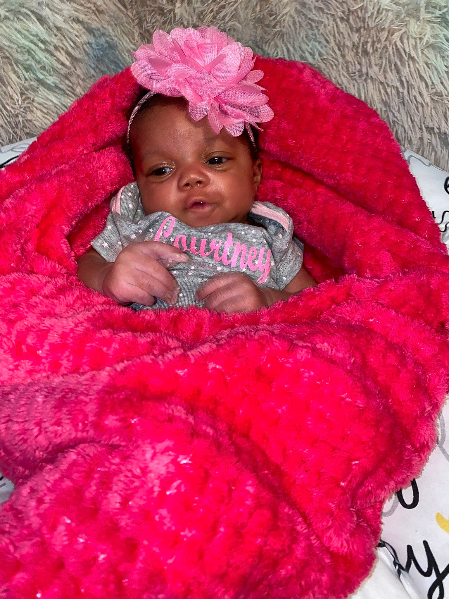 Courtney is registered to the contest to win money with this photo: baby, baby_products, child, crochet, hair_accessory, headgear, knitting, magenta, person, pink, product, textile, toddler, wool