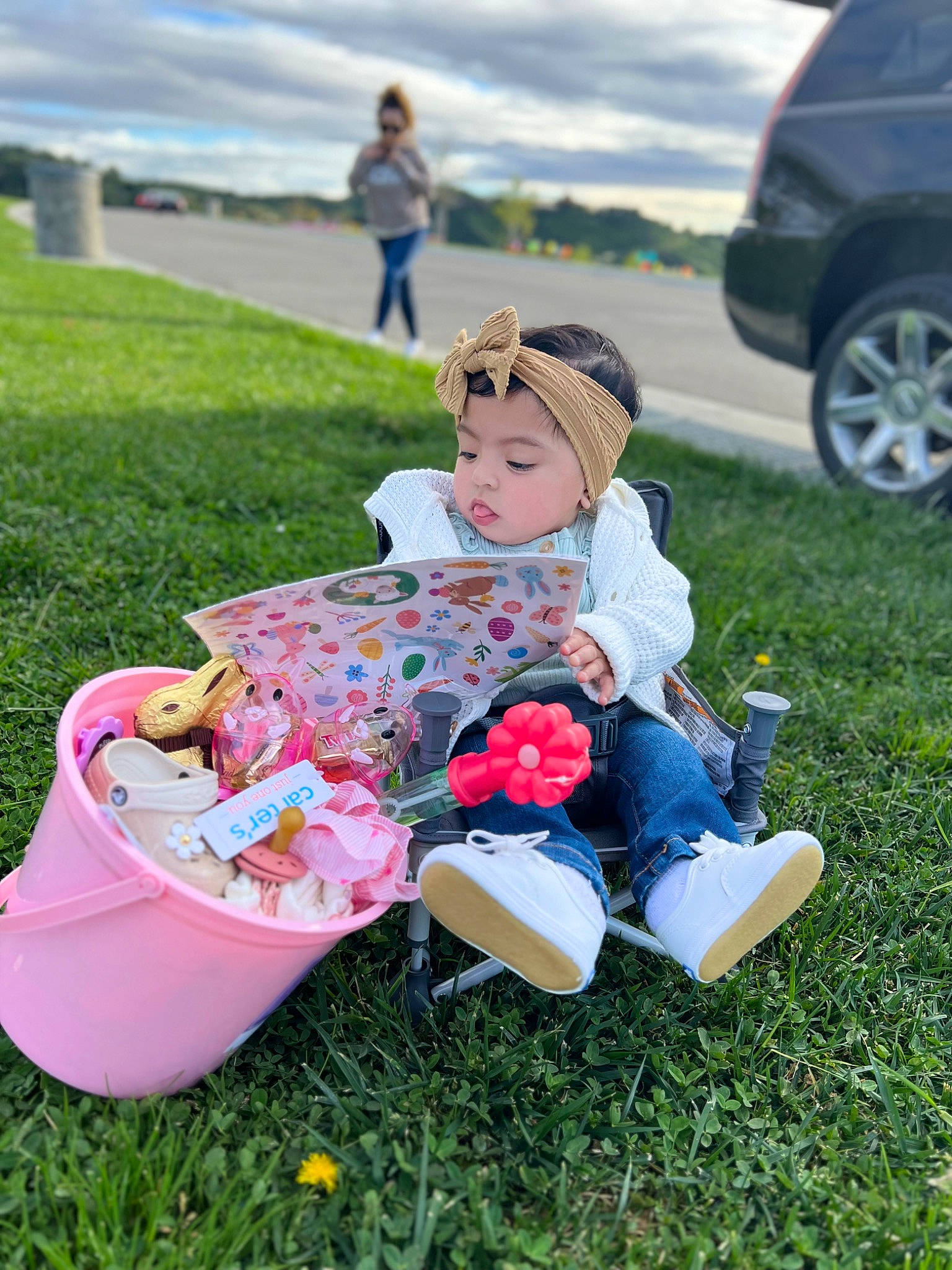 Camila joined the competition — help win amazing prizes! car, chair, child, event, fun, grass, happy, headwear, jeans, lawn, leisure, meadow, people_in_nature, person, plant, recreation, sky, summer, tire, toddler