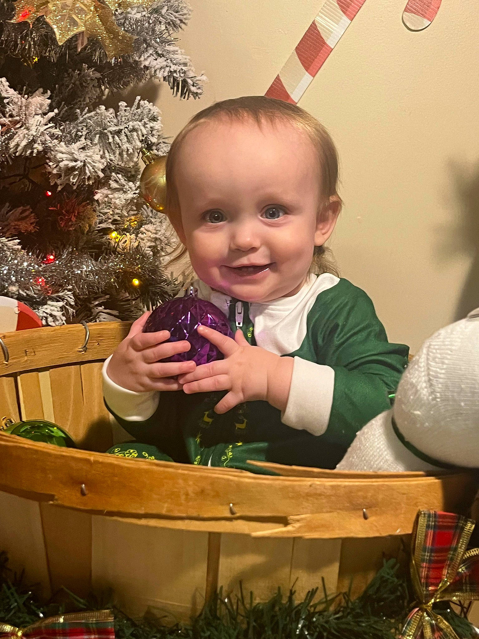 Owen is registered to the contest to win money with this photo: baby, baby_toddler_clothing, child, christmas, christmas_decoration, christmas_eve, christmas_ornament, christmas_tree, event, facial_expression, fun, grass, happy, holiday, joy, ornament, person, photograph, smile, snapshot