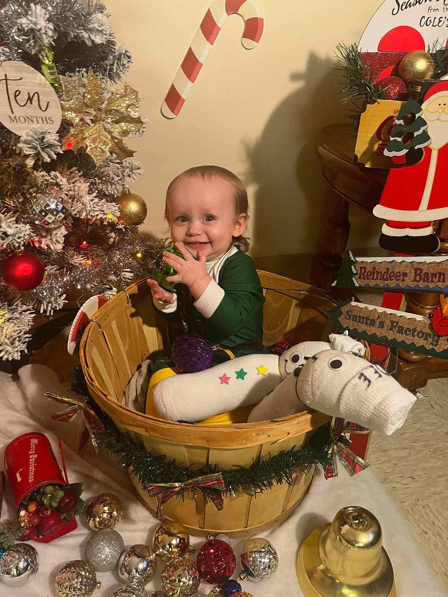 Owen is registered to the contest to win money with this photo: baby, carmine, christmas, christmas_decoration, christmas_eve, christmas_ornament, christmas_tree, event, happy, holiday, holiday_ornament, interior_design, joy, ornament, person, photograph, room, serveware, smile, snapshot