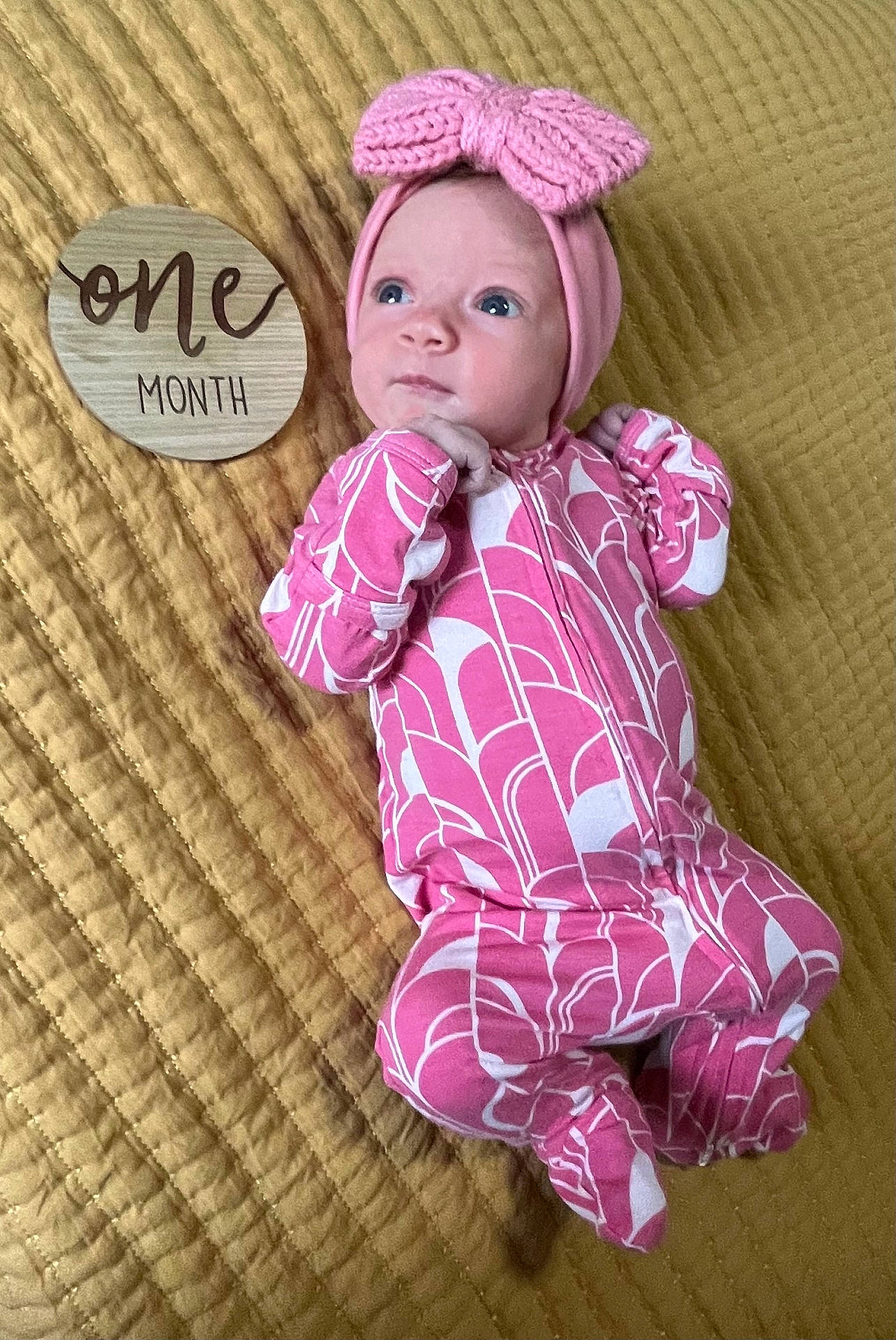 Georgia is registered to the contest to win money with this photo: baby, blanket, bonnet, cap, clothing, costume, couch, cushion, face, furniture, hat, head, newborn, pajamas, person, photography, portrait, quilt, sitting, toy