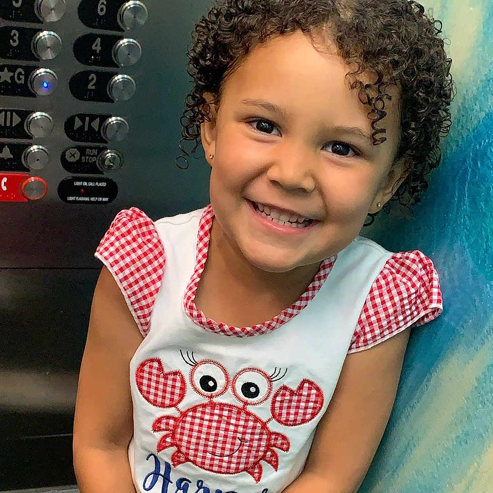 Harper is registered to the contest to win money with this photo: baby, babylaughing, blackhair, child, clothing, curlyhair, dimples, electricaldevice, face, female, girl, hair, happy, head, person, photography, portrait, sleeve, smile, switch