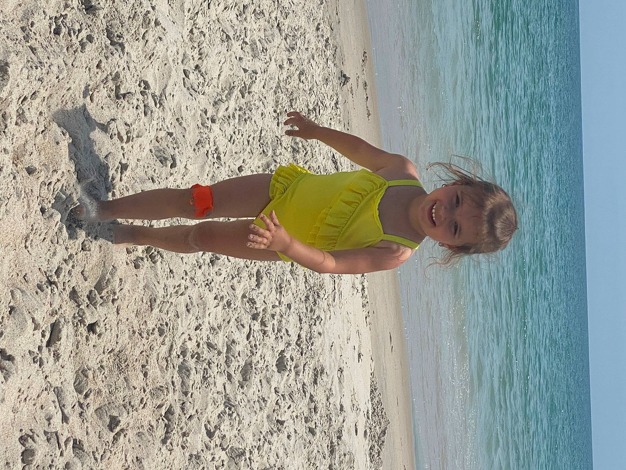 Lucia is registered to the contest to win money with this photo: barefoot, beach, dress, elbow, fun, happy, human_leg, joy, lake, leisure, people_in_nature, people_on_beach, person, recreation, sand, sky, summer, thigh, waist, water