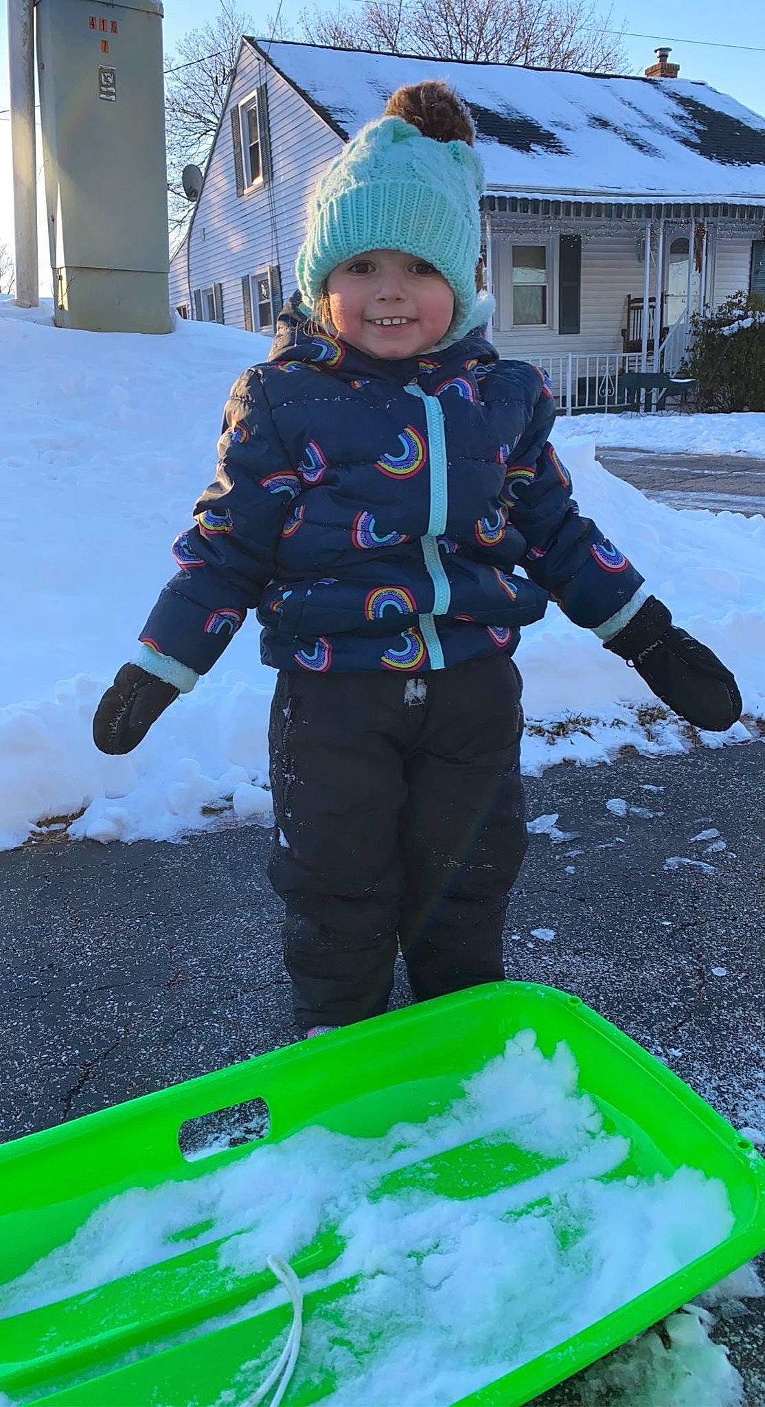 Lucia is registered to the contest to win money with this photo: baby_toddler_clothing, blue, child, freezing, fun, grass, green, headwear, joy, leisure, people_in_nature, person, photograph, play, recreation, smile, snapshot, snow, soil, toddler