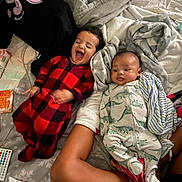 Jahkai is registered to the contest to win money with this photo: baby, infant, toddler, children, siblings, laughing, smiling, portrait, bed, blanket, pillow, pajamas, onesie, sleeping, indoor, bedroom, cozy, remote_control, package, family