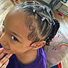 Iyasia joined the competition — help win amazing prizes! child, girl, toddler, portrait, close_up, face, braids, pigtails, hair_bows, purple_shirt, sideways_glance, indoors, home, playroom, toys, rainbow, chair, colorful, sitting, happy
