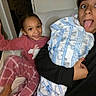 Iyasia joined the competition — help win amazing prizes! child, toddler, baby, adult, family, selfie, smiling, waving, toy, blanket, bed, indoors, portrait, face, tongue_out, pink_clothing, black_clothing, infant, sitting, happy