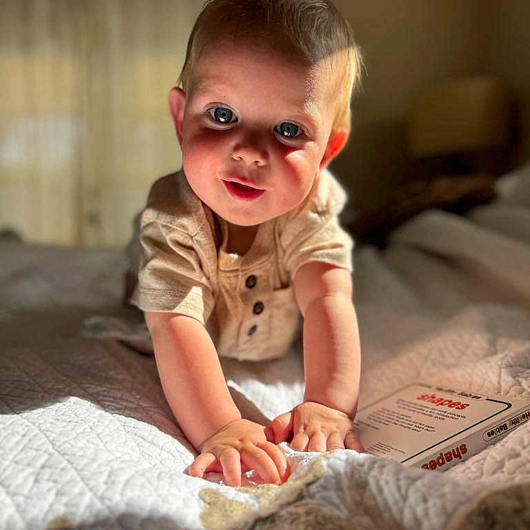 Beacon joined the competition — help win amazing prizes! baby, bed, bedroom, bodypart, crawling, face, finger, furniture, hand, happy, head, indoors, person, photography, portrait, reading, room, sitting, smile, text