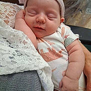 Lotus joined the competition — help win amazing prizes! baby, sleeping, headband, onesie, dinosaur_pattern, arm, hand, lace, fabric, infant, cute, peaceful, soft, closeup, child, person, newborn, resting, tender, cozy