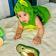 Ronald is registered to the contest to win money with this photo: baby, child, costume, green, avocado, balloon, blanket, cute, indoor, playful, smiling, face, hand, soft, toy, infant, curious, crawling, cute_outfit, toddler