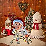 Ronald joined the competition — help win amazing prizes! baby, child, christmas, holiday, santa_hat, pajamas, snowman, christmas_tree, decorations, string_lights, fluffy_rug, festive, indoor, cute, holiday_lights, wooden_floor, heart_wreath, plush_toys, red_scarf, winter